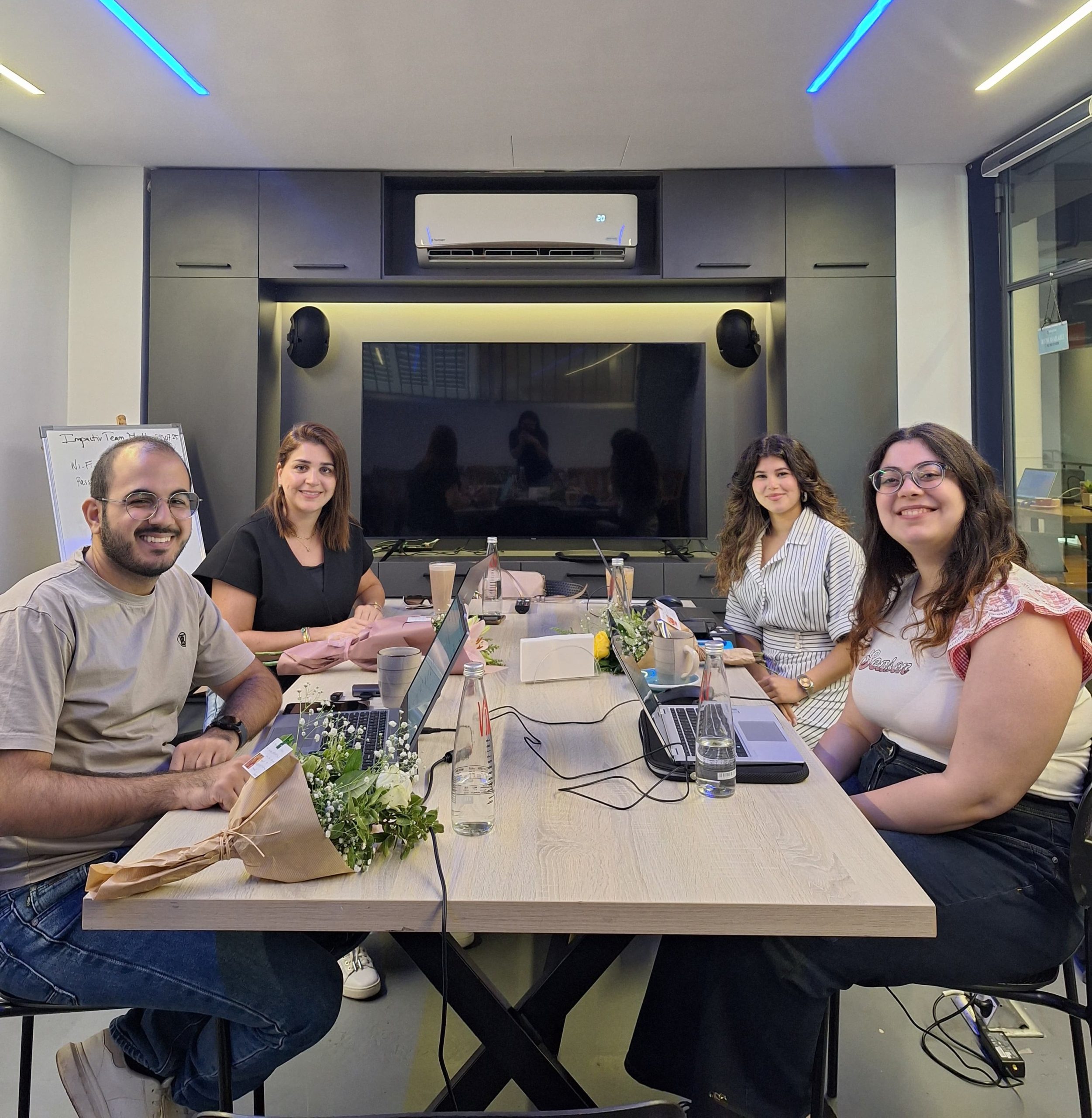 Impactiv team members collaborating during a meeting